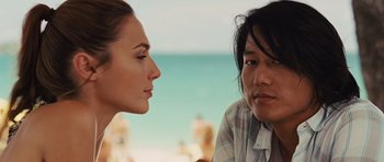 Movie still from “Fast Five” (2011), directed by Justin Lin – A man and a woman sitting next to each other on the beach; Close Up shot, Over the shoulder angle
