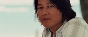 Movie still from “Fast Five” (2011), directed by Justin Lin – A person with long black hair; Close Up shot, Low angle