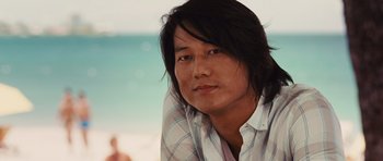 Movie still from “Fast Five” (2011), directed by Justin Lin – A person with long black hair; Close Up shot, Over the shoulder angle