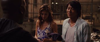 Movie still from “Fast Five” (2011), directed by Justin Lin – A man and a woman standing next to each other in front of a building; Medium shot, Over the shoulder angle