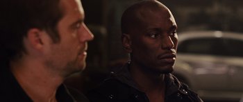 Movie still from “Fast Five” (2011), directed by Justin Lin – Two men sitting next to each other in a dark room; Close Up shot, Over the shoulder angle