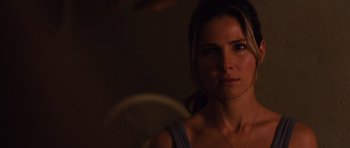 Movie still from “Fast Five” (2011), directed by Justin Lin – A beautiful woman standing in the dark with a light shining on her face; Close Up shot, Over the shoulder angle
