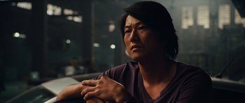 Movie still from “Fast Five” (2011), directed by Justin Lin – A man sitting in front of a window with his hand on his chest; Close Up shot, Over the shoulder angle