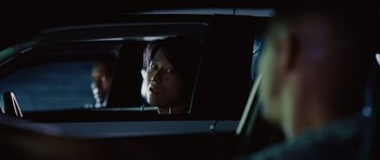Movie still from “Fast Five” (2011), directed by Justin Lin – A person in a car looking into a rear view mirror; Close Up shot, Over the shoulder angle