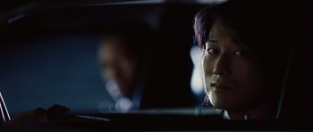 Movie still from “Fast Five” (2011), directed by Justin Lin – A man sitting in a car looking at the camera; Close Up shot, Over the shoulder angle