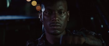 Movie still from “Fast Five” (2011), directed by Justin Lin – A man's face in the dark; Close Up shot, Low angle