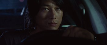 Movie still from “Fast Five” (2011), directed by Justin Lin – A man sitting in a car looking at the camera; Close Up shot, Over the shoulder angle