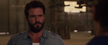 Movie still from “Fast Five” (2011), directed by Justin Lin – A man with a goatee is looking at the camera; Close Up shot, Over the shoulder angle