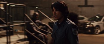 Movie still from “Fast Five” (2011), directed by Justin Lin – A man in a police uniform standing in front of another man; Close Up shot, Over the shoulder angle