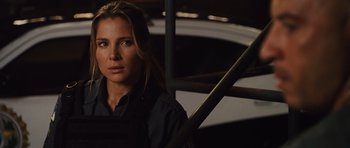 Movie still from “Fast Five” (2011), directed by Justin Lin – A woman in black shirt holding a baseball bat; Close Up shot, Over the shoulder angle