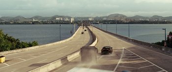 Movie still from “Fast Five” (2011), directed by Justin Lin – Cars driving on a bridge over a body of water; Extreme Wide shot, High angle