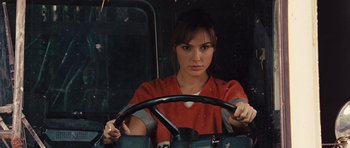Movie still from “Fast Five” (2011), directed by Justin Lin – A woman driving a car in a red shirt; Close Up shot, Over the shoulder angle