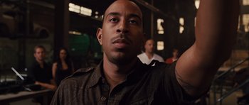 Movie still from “Fast Five” (2011), directed by Justin Lin – A person wearing a brown shirt; Close Up shot, Low angle