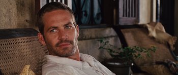 Movie still from “Fast Five” (2011), directed by Justin Lin – A person wearing a white shirt; Close Up shot, Over the shoulder angle