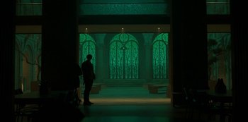 Movie still from “Fate: The Winx Saga” (2021), created by Brian Young – A man standing in front of a window at night; Extreme Wide shot, Low angle