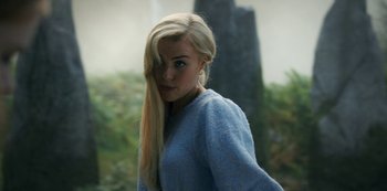 Movie still from “Fate: The Winx Saga” (2021), created by Brian Young – A woman with long blonde hair wearing a blue sweater; Close Up shot, Over the shoulder angle