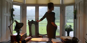 Movie still from “Fate: The Winx Saga” (2021), created by Brian Young – A woman standing in front of an open window; Medium shot, Low angle