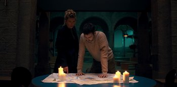 Movie still from “Fate: The Winx Saga” (2021), created by Brian Young – A man and a woman looking at a map; Medium shot, High angle