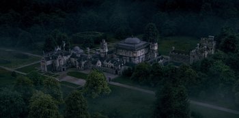 Movie still from “Fate: The Winx Saga” (2021), created by Brian Young – An aerial view of an old mansion in the middle of the night; Extreme Wide shot, High angle