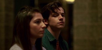 Movie still from “Fate: The Winx Saga” (2021), created by Brian Young – A man and a woman are standing next to each other; Close Up shot, Over the shoulder angle