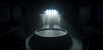 Movie still from “Fate: The Winx Saga” (2021), created by Brian Young – A dark room with a light shining on it; Extreme Wide shot, Low angle