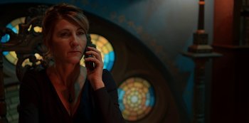 Movie still from “Fate: The Winx Saga” (2021), created by Brian Young – A woman holding a cell phone up to her ear; Close Up shot, Low angle