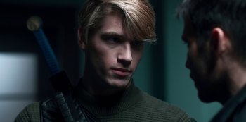 Movie still from “Fate: The Winx Saga” (2021), created by Brian Young – A person wearing a sweater; Close Up shot, Over the shoulder angle