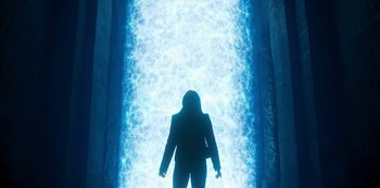Movie still from “Fate: The Winx Saga” (2021), created by Brian Young – A woman standing in front of a large blue light; Wide shot, Low angle