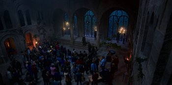 Movie still from “Fate: The Winx Saga” (2021), created by Brian Young – A group of people standing in front of stained glass windows; Extreme Wide shot, High angle
