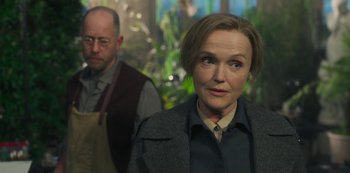 Movie still from “Fate: The Winx Saga” (2021), created by Brian Young – A man and a woman standing next to each other in front of plants; Medium shot, Over the shoulder angle