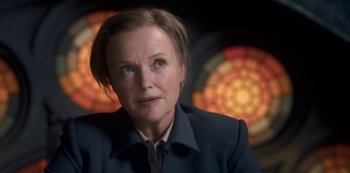 Movie still from “Fate: The Winx Saga” (2021), created by Brian Young – A person wearing a suit; Close Up shot, Low angle