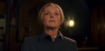 Movie still from “Fate: The Winx Saga” (2021), created by Brian Young – A woman with short blonde hair wearing a blue jacket; Close Up shot, Low angle