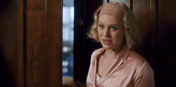 Movie still from “Fate: The Winx Saga” (2021), created by Brian Young – A woman with blonde hair wearing a pink shirt and a headband; Close Up shot, Over the shoulder angle