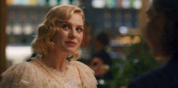 Movie still from “Fate: The Winx Saga” (2021), created by Brian Young – A woman with blonde hair wearing a white dress; Close Up shot, Over the shoulder angle