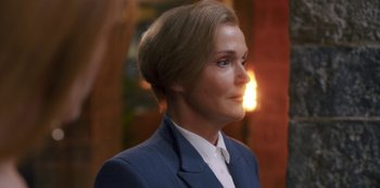 Movie still from “Fate: The Winx Saga” (2021), created by Brian Young – A person wearing a suit; Close Up shot, Over the shoulder angle