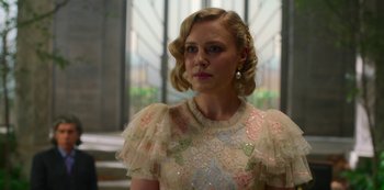 Movie still from “Fate: The Winx Saga” (2021), created by Brian Young – A woman with blonde hair wearing a white dress; Close Up shot, Over the shoulder angle