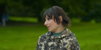 Movie still from “Fate: The Winx Saga” (2021), created by Brian Young – A young woman with brown hair and a brown jacket; Close Up shot, Over the shoulder angle