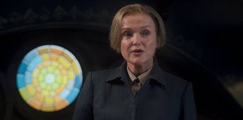 Movie still from “Fate: The Winx Saga” (2021), created by Brian Young – A woman with blonde hair wearing a black jacket; Close Up shot, Low angle