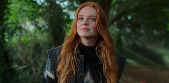 Movie still from “Fate: The Winx Saga” (2021), created by Brian Young – A beautiful young lady with long red hair; Close Up shot, Low angle