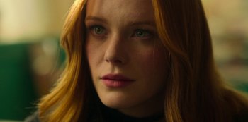 Movie still from “Fate: The Winx Saga” (2021), created by Brian Young – A woman with red hair and green eyes; Close Up shot, Low angle