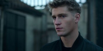 Movie still from “Fate: The Winx Saga” (2021), created by Brian Young – A person wearing a black shirt; Close Up shot, Over the shoulder angle