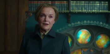 Movie still from “Fate: The Winx Saga” (2021), created by Brian Young – A woman with blonde hair wearing a green jacket; Close Up shot, Low angle