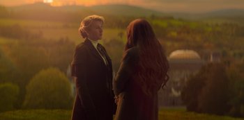 Movie still from “Fate: The Winx Saga” (2021), created by Brian Young – Two women standing next to each other on a field; Medium shot, Over the shoulder angle