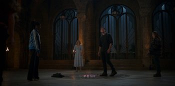 Movie still from “Fate: The Winx Saga” (2021), created by Brian Young – A man and a woman standing in front of candles; Wide shot, Low angle