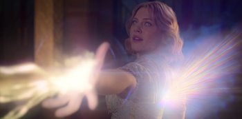 Movie still from “Fate: The Winx Saga” (2021), created by Brian Young – A woman is holding a gun and aiming at something; Close Up shot, Low angle