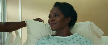 Movie still from “Fatherhood” (2021), directed by Paul Weitz – A woman in a hospital gown looking into the distance; Close Up shot, Over the shoulder angle