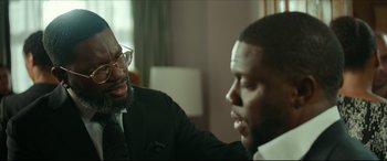 Movie still from “Fatherhood” (2021), directed by Paul Weitz – Two men sitting in a room talking to each other; Close Up shot, Over the shoulder angle