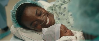 Movie still from “Fatherhood” (2021), directed by Paul Weitz – A woman and a baby laying in a hospital bed; Close Up shot, Overhead angle