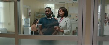 Movie still from “Fatherhood” (2021), directed by Paul Weitz – A man and a woman are standing in front of a mirror; Medium shot, Over the shoulder angle