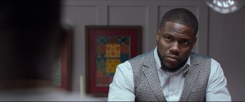 Movie still from “Fatherhood” (2021), directed by Paul Weitz – A person sitting in a room; Close Up shot, Over the shoulder angle